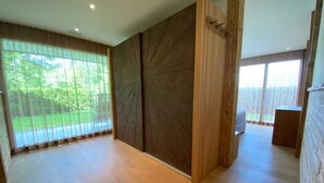 A spacious room with large windows, a wooden floor, and a modern design. - Eden 3 by Arosa Holiday Appartement/Fewo, Bad, WC, 6-Bettwohnung by Interhome (Arosa)