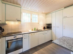 A modern kitchen with white cabinets, a built-in oven, a microwave, and a sink. - Les Chamois Appartement/Fewo,  , 8-Bettwohnung 8-Bettwohnung by Interhome (Arosa)