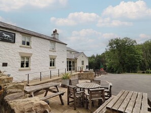 A white building with a sign reading 'The White Lion.' - Upstairs at the White Lion (Holywell)