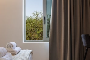 A room with a bed, a window with curtains, and a chair. - Marvelous new Luxury Villa With Heated Pool! (Rethymno)