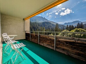 A balcony with a view of a forest and mountains. - Rothornblick 44 by Arosa Holiday Appartement/Fewo,   Schöne 2½-Zimmerwohnung by Interhome (Arosa)