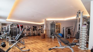 A gym with various exercise equipment, including treadmills, elliptical machines, and weightlifting stations. - Rothornblick 44 by Arosa Holiday Appartement/Fewo,   Schöne 2½-Zimmerwohnung by Interhome (Arosa)