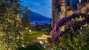 A stone building with a view of a city and a mountain in the background.