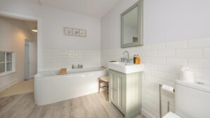 A bathroom with a bathtub, a sink, and a toilet.