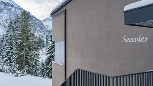 A building with a 'Seewies' sign, surrounded by snow-covered mountains and trees. - Fürggli Appartement/Fewo, Dusche und Bad, WC, Erdgeschoß/Parterre by Interhome (Arosa)