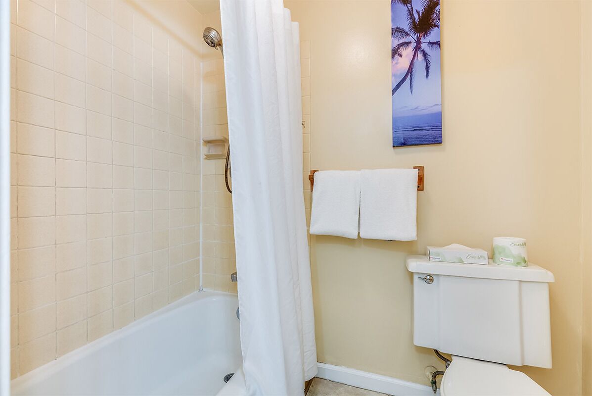 Your private bathroom features a tub-shower combo with fresh towels and complimentary toiletries to refresh after adventures.