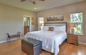 A bedroom with a large bed, a desk, a chair, a bench, and a window with a view of trees. - New Listing! Golf Course & Mtn Views | A/C | Spacious Townhome (Pagosa Springs)