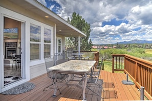A covered deck with a table and chairs, a grill, and a view of mountains. - New Listing! Golf Course & Mtn Views | A/C | Spacious Townhome (Pagosa Springs)