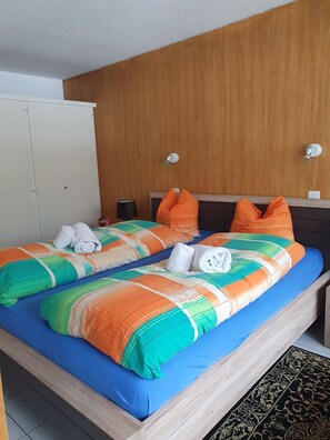 A hotel room with a bed, a wardrobe, and a nightstand. - Fortuna 403 # 4-bed apartment, Dusche, WC 4-Bettwohnung, Dusche, WC by Interhome (Leukerbad)