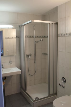 A bathroom with a glass-enclosed shower, a sink, and a toilet. - Salute 206 # 4-bed apartment, Dusche, WC 4-Bettwohnung, Dusche, WC by Interhome (Leukerbad)