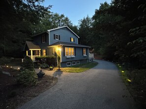 A two-story house with a driveway leading to the front door. - Spacious 5-bedroom house for the whole family (Laconia)