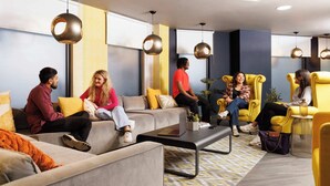 A modern lounge area with sofas, armchairs, and a coffee table. - Student Only Brass Founders (Sheffield)