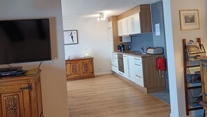 A modern kitchen with white cabinets, a wooden countertop, and a built-in oven. - Frégate 44 # 4-bed apartment, Dusche, WC 4-Bettwohnung, Dusche, WC by Interhome (Leukerbad)