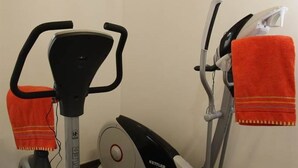An exercise machine, a towel, and a wall-mounted light fixture in a room. - Residenz Iris Leukerbad # 4-bed apartment, Dusche und Bad, WC by Interhome (Leukerbad)