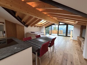 A modern kitchen with a dining area, wooden beams, and a view of mountains. - Diana 9 # 3-bed apartment, Dusche, WC 3-Bettwohnung, Dusche, WC by Interhome (Leukerbad)