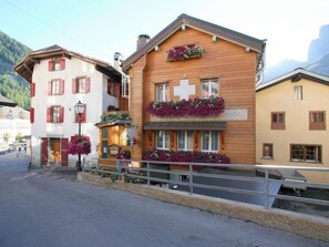 A hotel with a wooden facade, balconies with flowers, and a sign indicating it is a hotel. - Heimatkunst 1 (Lucia) # 5-bed apartment, Dusche, WC 5-Bettwohnung, Dusche, WC by Interhome (Leukerbad)