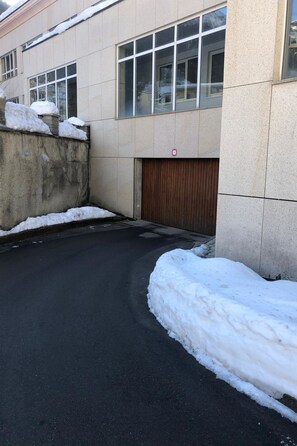 A building with a paved driveway and a gated entrance. - Leuca 11 # 2-bed apartment, Bad, WC 2-Bettwohnung, Bad, WC by Interhome (Leukerbad)