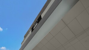 A building with a sign reading 'Café Ristorante' and a tiled ceiling. - Suite Budha Tower (Noida)