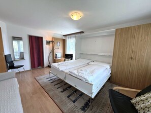 A modern bedroom with a bed, a desk, and a chair. - Royal 32 # 6-bed apartment, Dusche, WC 6-Bettwohnung, Dusche, WC by Interhome (Leukerbad)