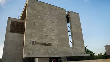 A modern building with a flat facade and a large open entrance.