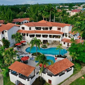A resort with a central swimming pool, multiple balconies, and lush greenery. - 2 bed Ocean View apartment  in Speightstown - Sand Dollar, Sand Street apt 1 (Speightstown)
