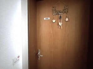 A wooden door with a decorative sign reading 'Welcome' and a small sign with the number '1808'. - Lärchenwald 1808 # 4-bed apartment, Bad, WC 4-Bettwohnung, Bad, WC by Interhome (Leukerbad)