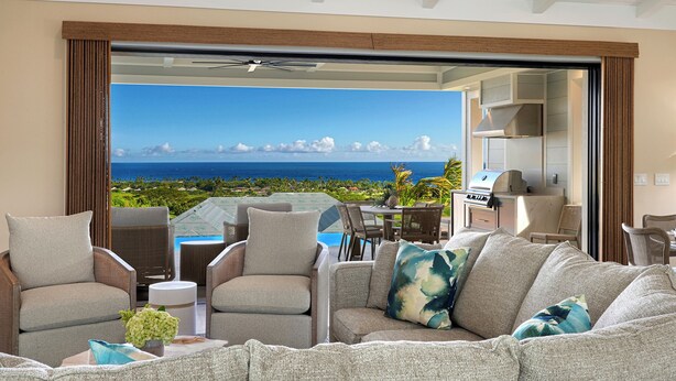 A living room with a sofa, chairs, a coffee table, and a view of the ocean. - Hali'a Mai Distant Ocean View Koloa Home w/ Pool (Koloa)