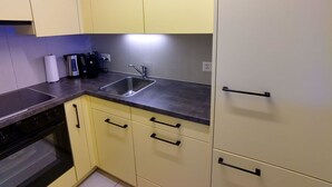 A kitchen with a sink, stove, and cabinets. - Valère C 222 # 2-bed apartment, Dusche, WC 2-Bettwohnung, Dusche, WC by Interhome (Leukerbad)