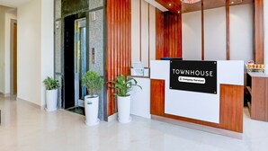 A reception desk with a sign reading 'TOWNHOUSE Company-Serviced.' - Premium Townhouse Majra Isbt Dehradun (Dehradun)