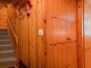 A wooden interior with a staircase, a door, and a light switch. - Furkablick Yvonne by Arosa Holiday Appartement/Fewo, Bad, WC Furkablick Yvonnne by Interhome (Arosa)