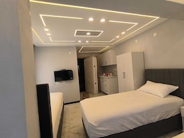 Luxury Room, Multiple Beds, Balcony, Garden View | Desk, laptop workspace