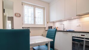 A compact kitchen with a window, a sink, and a built-in oven. - Casa Viktoria A37 by Arosa Holiday Appartement/Fewo, Dusche, WC, 4-Bettwohnung by Interhome (Arosa)