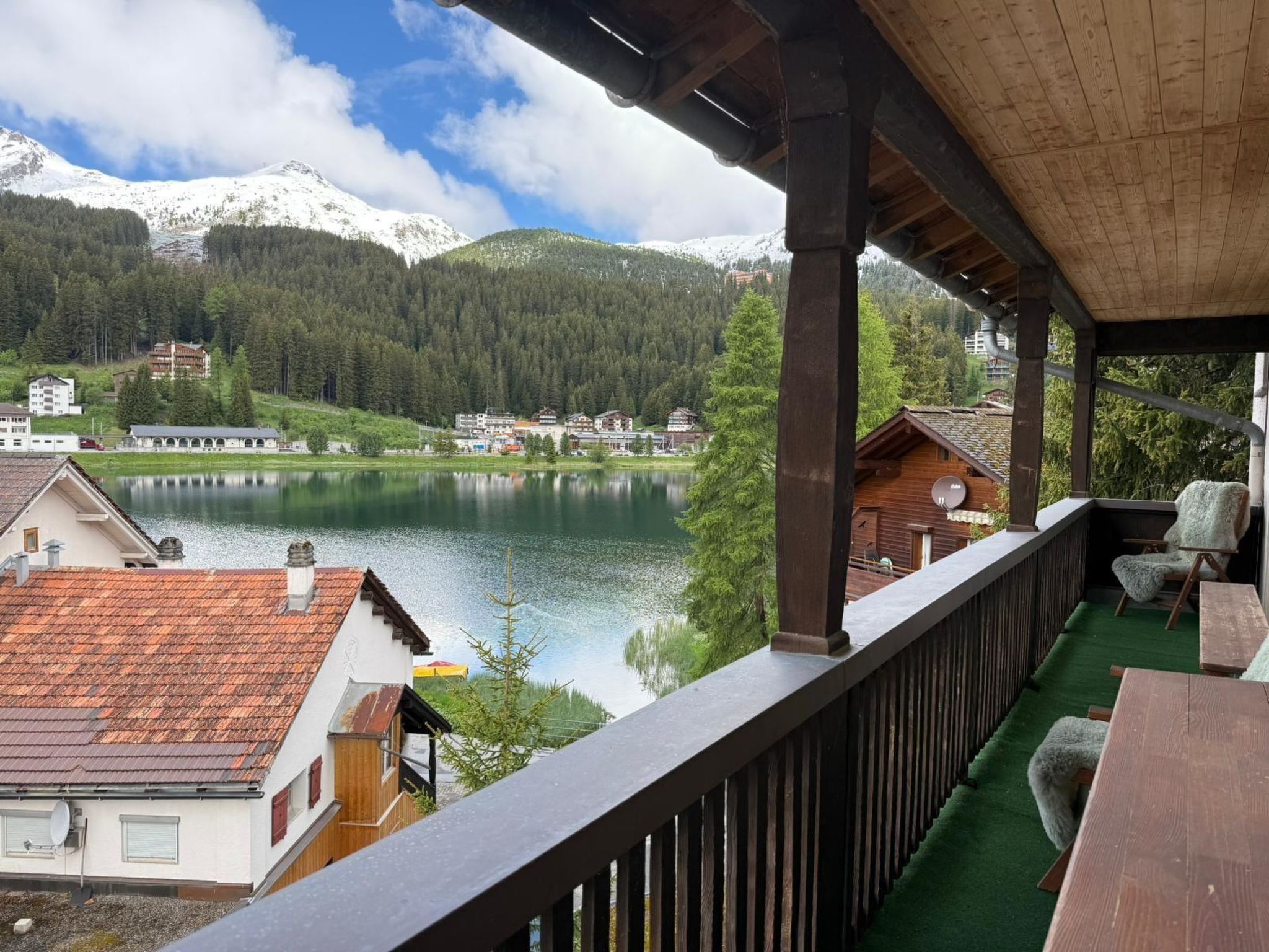 A balcony with a view of a lake and mountains.