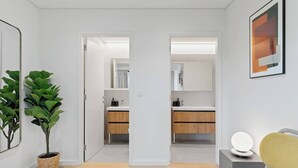 Un baño moderno con espejo, lavamanos y muebles de madera.