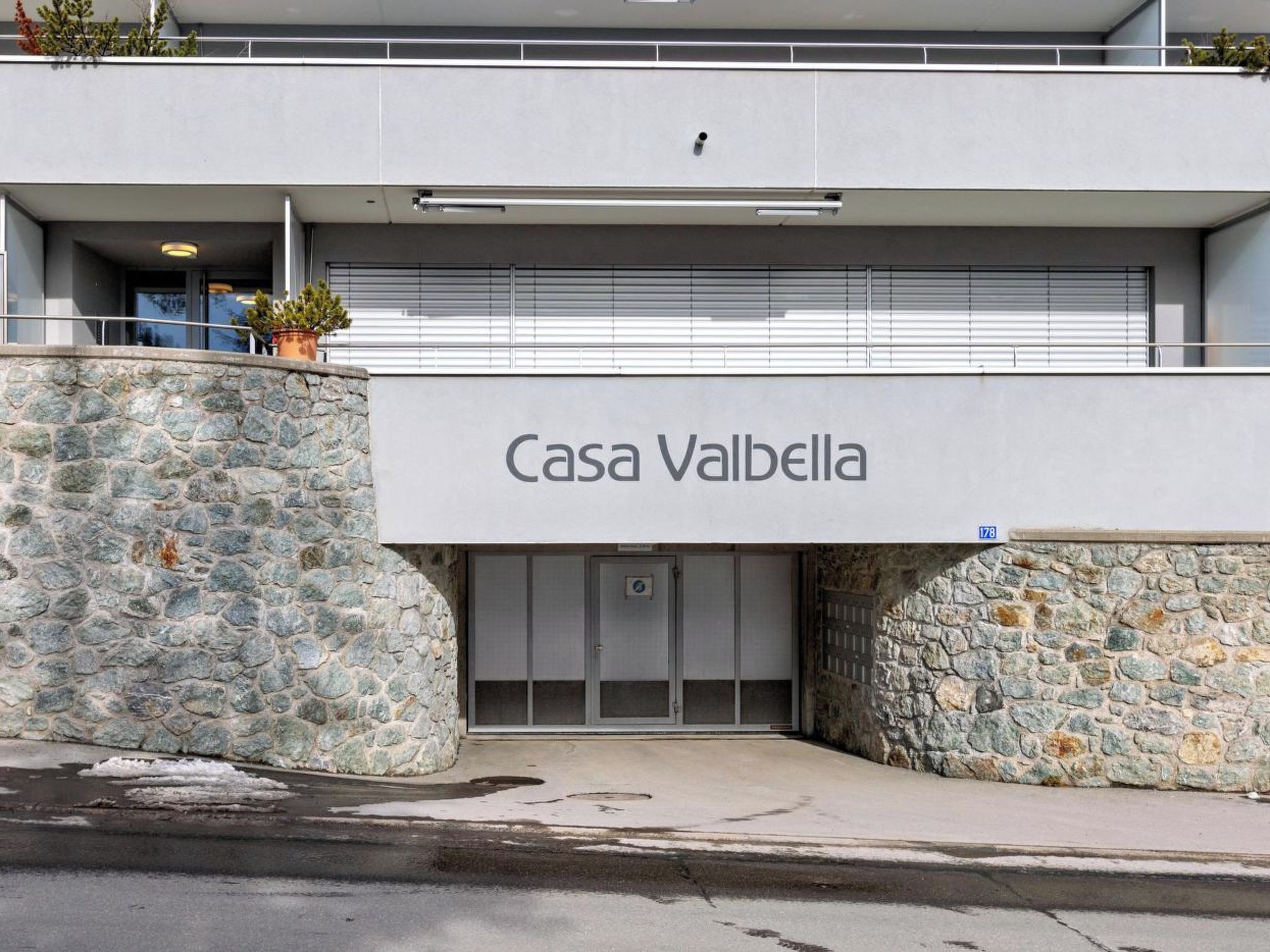 A building with a stone facade and a sign reading 'Casa Valbella.'