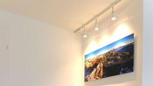 A light-colored sofa in a room with a wooden floor and a wall-mounted picture. - Jäggi 44 by Arosa Holiday Appartement/Fewo, Dusche und Bad, WC, 3-Bettwohnung by Interhome (Arosa)