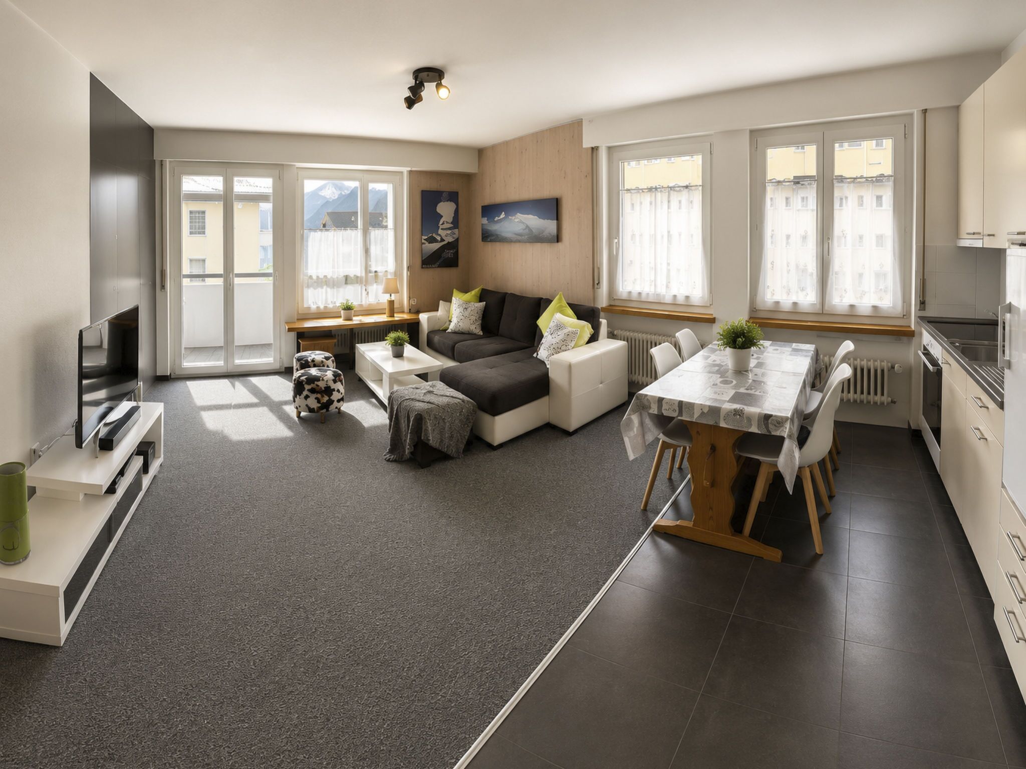 A modern apartment with a living area, dining space, and kitchen.
