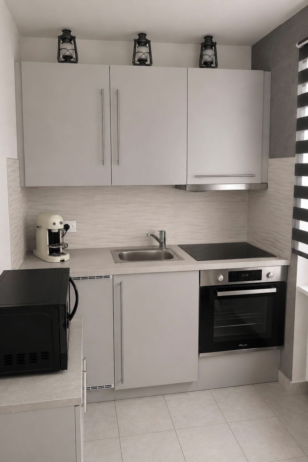 A modern kitchen with white cabinets, a coffee maker, a sink, a stove, and an oven.