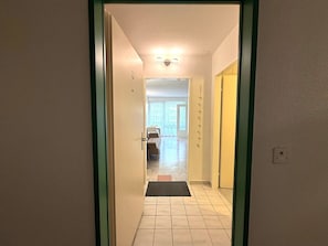 A hallway leading to a room with a bed and a window. - Fortuna 220 # 2-bed apartment, Dusche, WC 2-Bettwohnung, Dusche, WC by Interhome (Leukerbad)