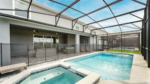 A pool area with a hot tub, seating, and a covered patio. - 4305-Lana (Davenport)