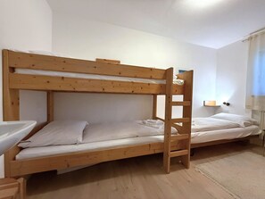 A bunk bed with a ladder, white bedding, and a small bedside table with a lamp. - Salve 8 # 5-bed apartment, Bad, WC 5-Bettwohnung, Bad, WC by Interhome (Leukerbad)