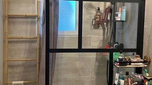 A bathroom with a shower, a sink with a basin, a towel rack, and a mirror. - House with a garden in Candillargues (Candillargues)