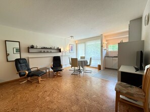 A living room with a dining area, a kitchen, and a TV. - Fortuna 118 # 2-bed apartment, Dusche, WC 2-Bettwohnung, Dusche, WC by Interhome (Leukerbad)