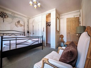 A bedroom with a bed, a wooden wardrobe, a mirror, and a lamp. - Paradies 507 Appartement/Fewo,  , 2-Bettwohnung by Interhome (Arosa)