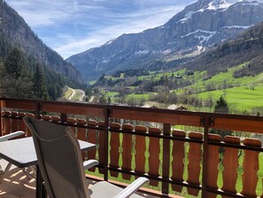 A balcony with a view of a mountainous landscape, including a valley and a road. - Edelweiss C 11 # 4-bed apartment, Dusche und Bad, WC by Interhome (Leukerbad)