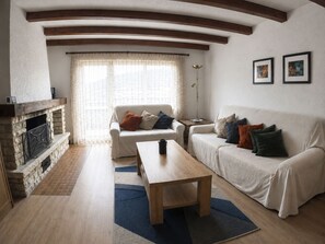 A living room with a fireplace, two sofas, a coffee table, and a rug. - Residenz Clabina Leukerbad # 6-bed apartment, Bad, WC by Interhome (Leukerbad)