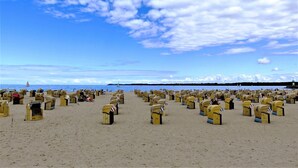 Une plage où de nombreuses boîtes aux lettres jaunes sont disposées en rangées.