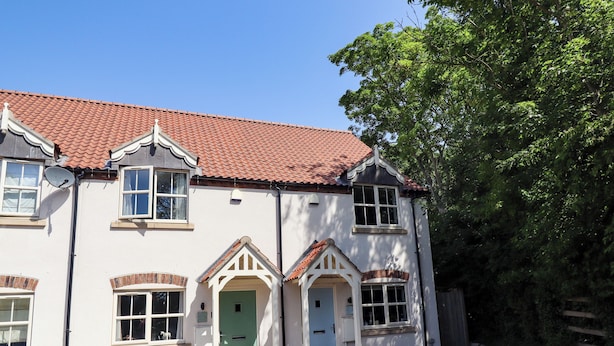 A two-story building with a red-tiled roof, white walls, and multiple windows. - Burton Fields (Driffield)