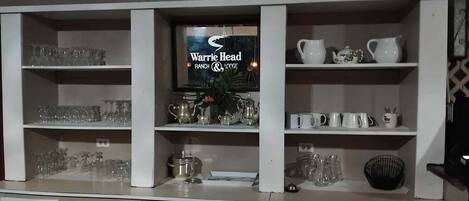 A display of glassware and kitchenware on shelves.