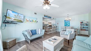 A living room with a sofa, chairs, a coffee table, and artwork on the walls. - Perfect family stay by Gulf & Lagoon! Dogs welcome (Gulf Shores)